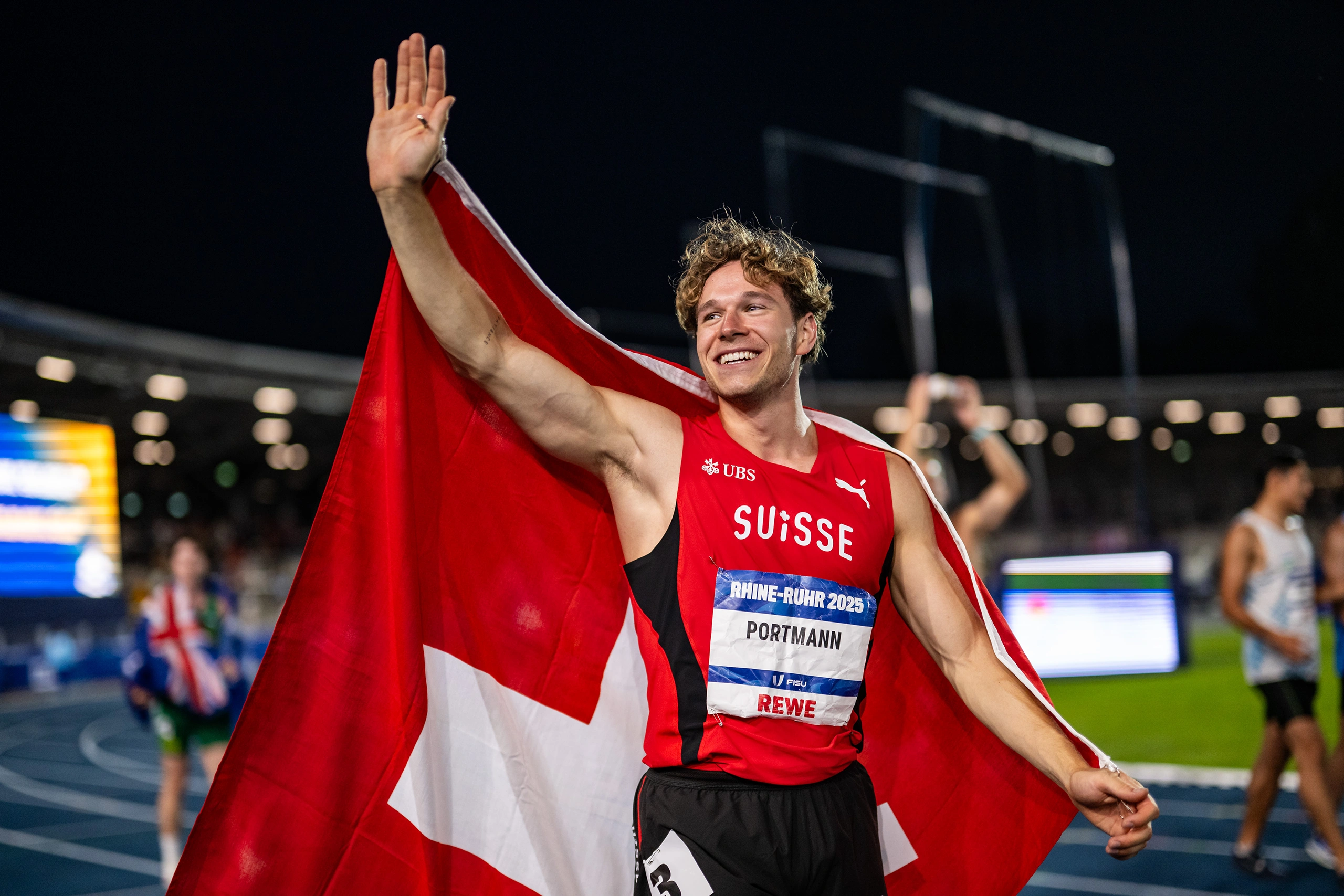 Nino Portmann feiert mit Schweizer Flagge